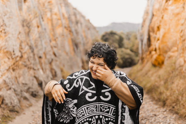 Laughing in nature with Aztec design poncho