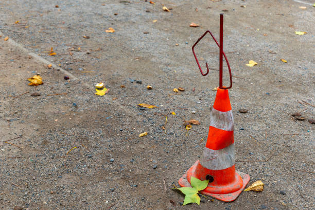 istock A traffic cone sits on a gravel road with some fallen leaves around it 2177547307