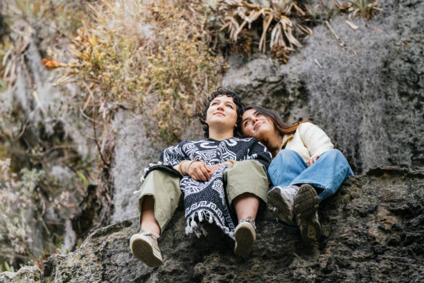 Friends Relaxing on Cliff Edge in Natural Surroundings