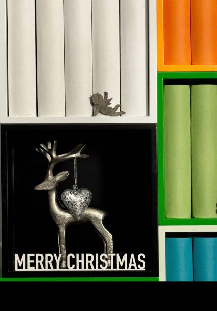 Christmas decoration in the library with deer, angel, and generic book spines
