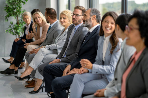 istock Business professionals seated attentively in modern office environment. 2177550216