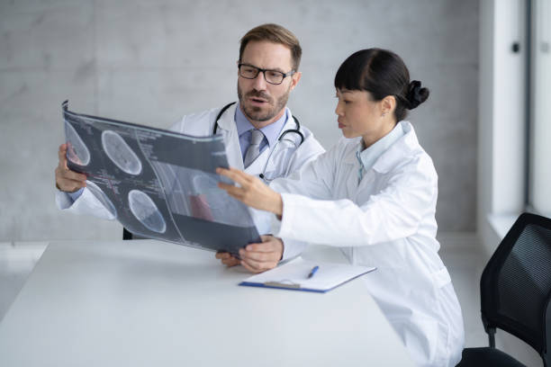 istock Focused doctors discussing and analyzing patient X-ray results carefully 2177550260