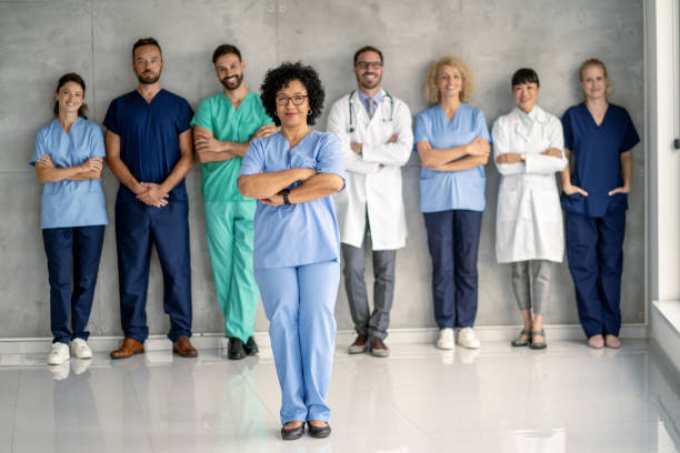 istock Assertive nurse in blue, diverse medical practitioners aligned behind her 2177550274