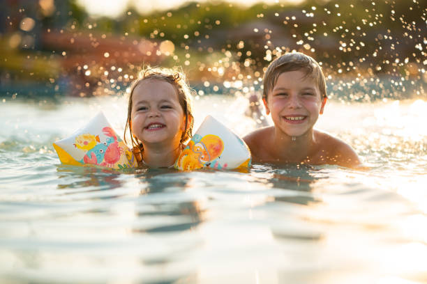 istock Kids having fun in swimming pool 2177552200