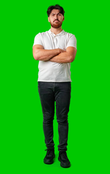A young man with a beard showing a serious expression against a vibrant green background