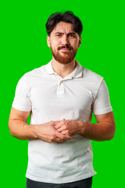 A young man with a beard showing a serious expression against a vibrant green background