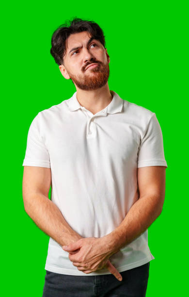 istock A man contemplates thoughtfully against a bright green background 2177555919