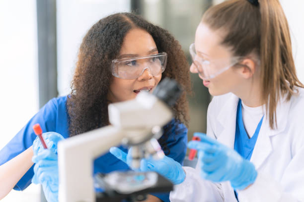 istock Two female scientists work in a laboratory with blood samples and test tubes filled with solution with pipettes from droppers while conducting research. 2177556251