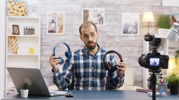 istock Famous vlogger recording a review and testing headphones 2177556400