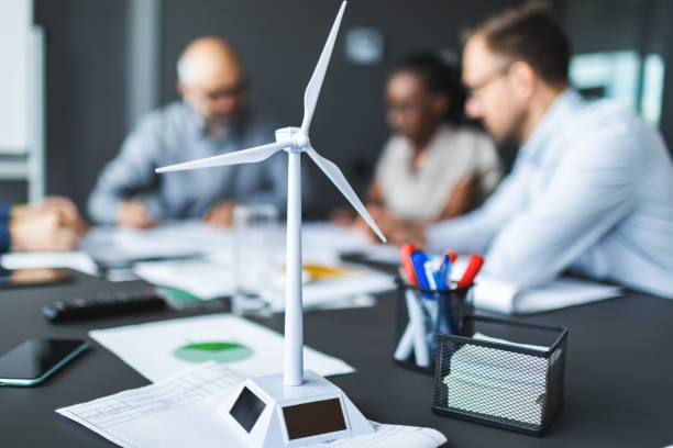 istock Colleagues discussing construction drawings on sustainable energy resources: windmills 2177556417