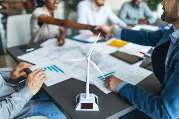 istock Colleagues discussing construction drawings on sustainable energy resources: windmills 2177556742