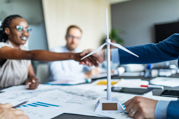 istock Colleagues discussing construction drawings on sustainable energy resources: windmills 2177556949