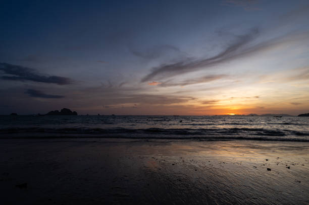 Picturesque seascape view of Nopparat Thara Beach at sunset in Krabi province. Landscape of tropical island beach.