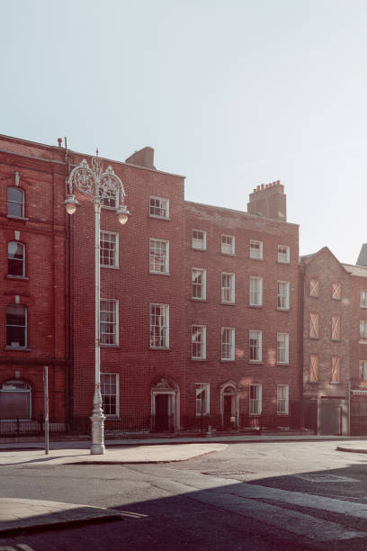 istock Dublin red brick Georgian buildings are bathed in soft, nostalgic light in this vertical shot. The vintage effect enhances the timelessness of the architecture, with a decorative streetlamp 2177559456
