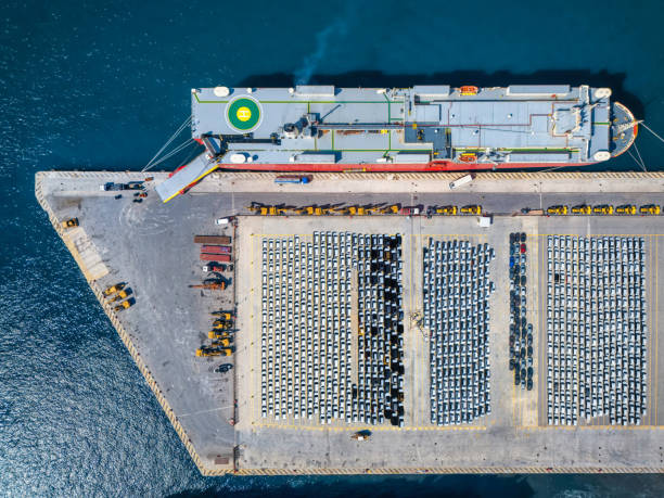 istock Aerial top down view of a car port terminal with a cargo ship unloading 2177560175