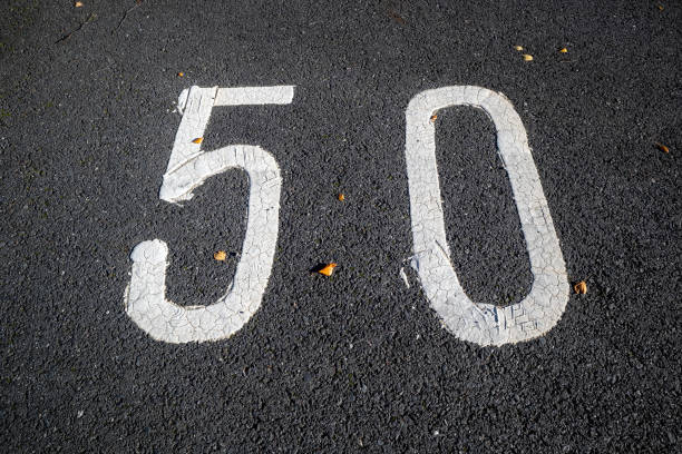istock Number fifty 50 painted in white on tarmac 2177562111