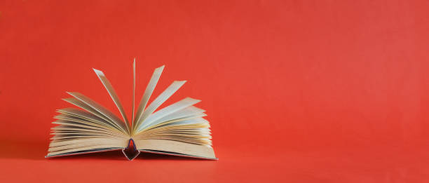 istock Open book, Reading, learning, education or home office business concept.Red background, free copy space. 2177562564