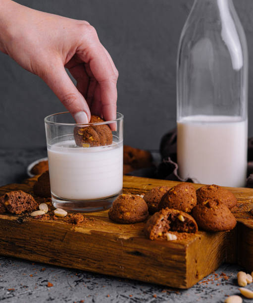 istock Hand dipping cookie into glass of milk 2177564737