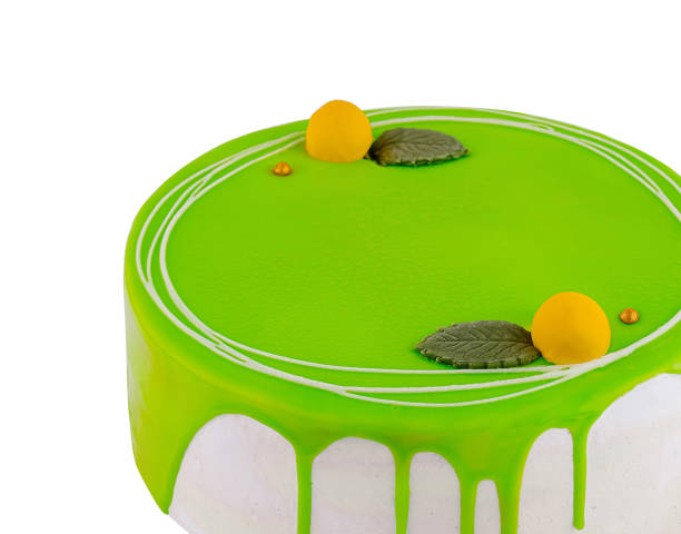 istock Delicious green cake decorated with lemon and mint leaves on white background 2177564973