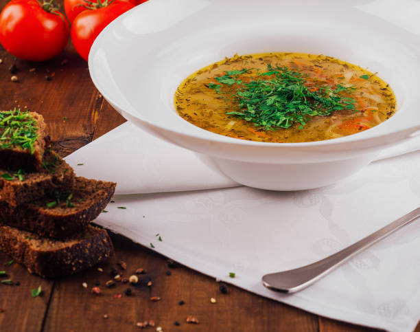 istock Delicious chicken soup with vegetables served on rustic wooden table 2177565157