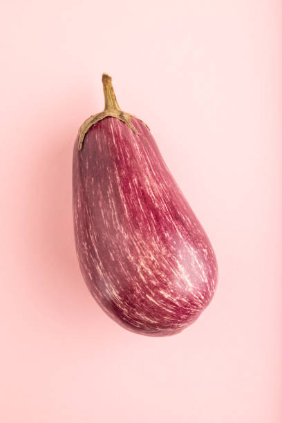 istock Purple eggplant with white stripes on pink pastel, Top view, copy space. 2177570541