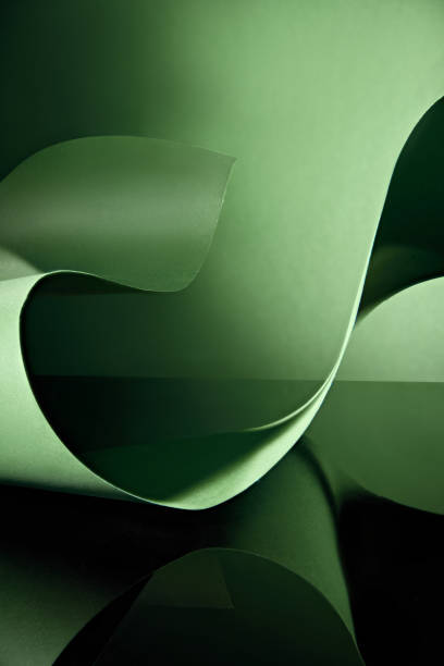 istock With a dark green backdrop and a green paper ribbon that twists and flows to create a beautiful wave-like pattern, this high-quality picture template leaves room for display text and products. 2177571480
