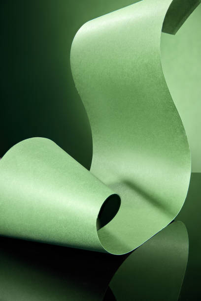 istock A minimalist and elegant visual feature a green paper ribbon gently curves and flows, creating a soft arch against a dark green background suitable for displaying products. 2177571481
