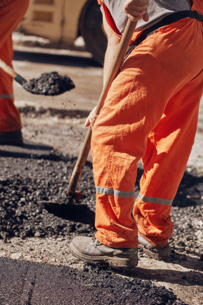 istock Construction workers working on a new asphalt layer on a public street. 2177573262
