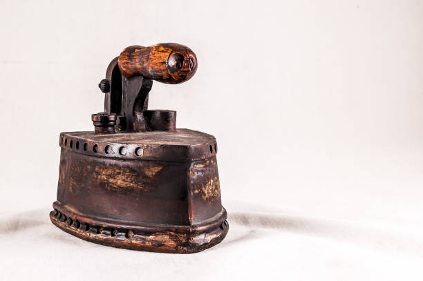 istock An old fashioned iron with a wooden handle sits on a white background 2177578060