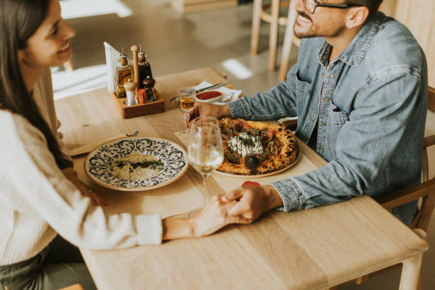 istock A joyful dinner date with delicious dishes and laughter in a cozy restaurant setting 2177581468