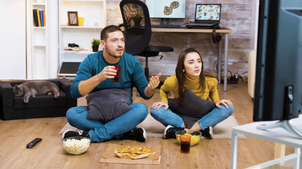 istock Young couple sitting on the floor cheering up 2177582530