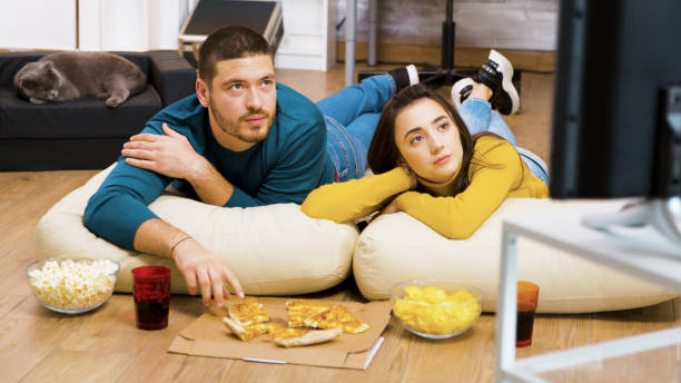 istock Attractive couple relaxing on pillows for the floor 2177582758