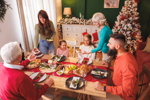 istock Women setting the table for family Christmas dinner 2177583497