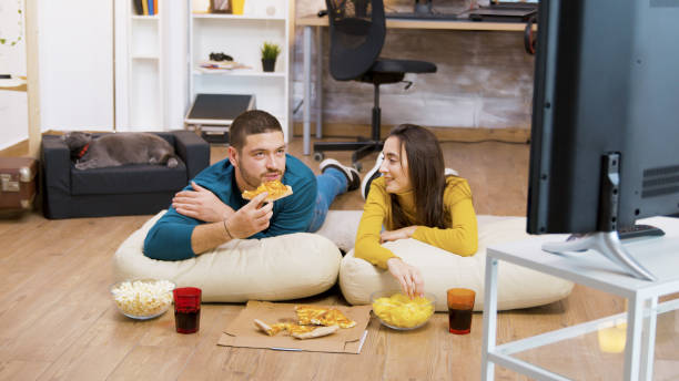 istock Bearded man drinking soda and sitting on pillows for the floor 2177583764