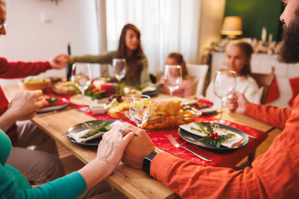 istock Family praying before Christmas dinner at home 2177583877