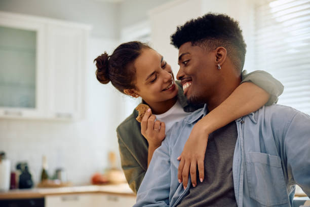 istock Happy multiracial couple talking face to face in the kitchen. 2177584507