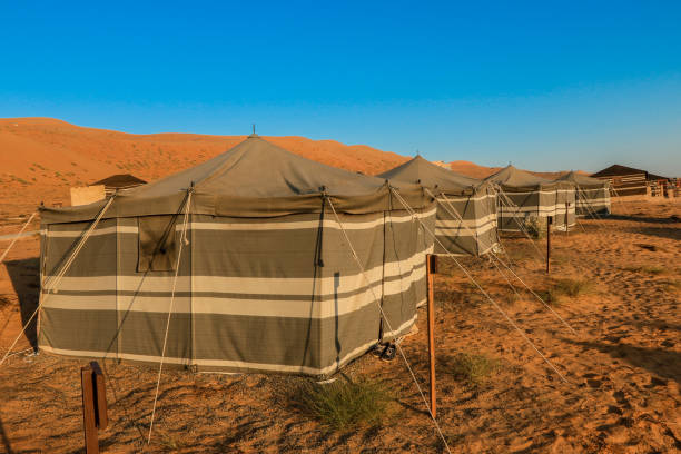istock Explore luxury tent accommodations in the serene desert landscape of Oman during sunset with stunning dunes in the background 2177586754