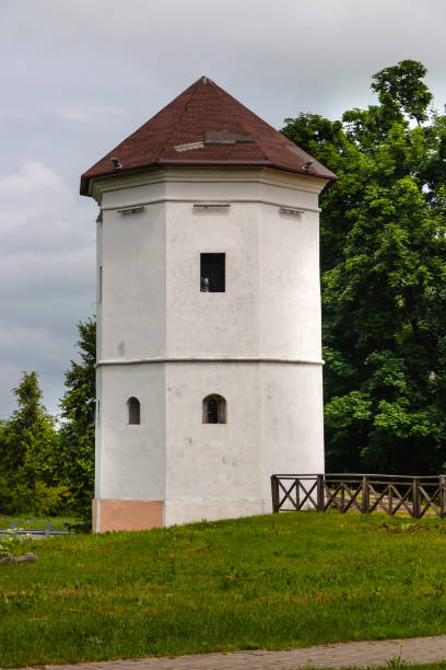 istock White medieval defensive tower in the park with trees in the background and cloudy sky 2177587596
