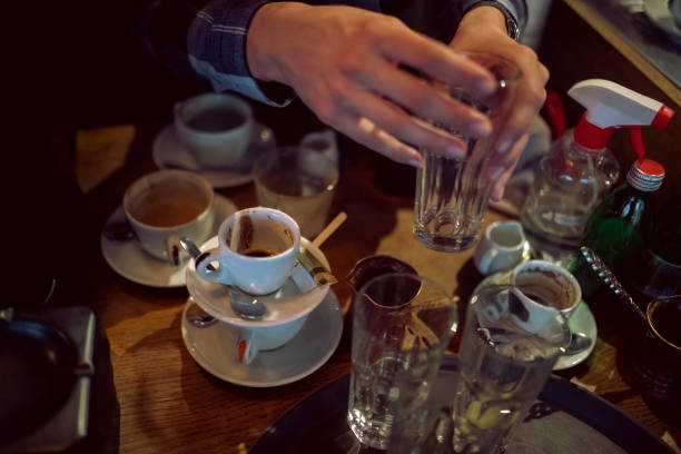 After the guests leave the restaurant, the waitress takes the dirty dishes to wash them.