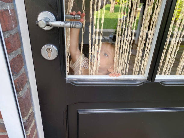 istock Baby boy playing Peekaboo behind the window 2177587802