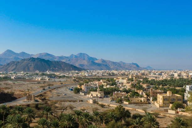 istock Panoramic view of a tranquil Omani town surrounded by mountains and palm trees on a clear sunny day 2177589600