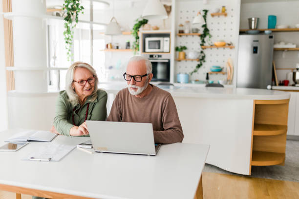 istock Senior couple using laptop while planning their home budget, 2177592293