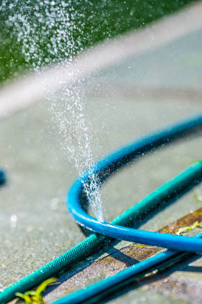 istock Large water leak in a blue garden water hose.. 2177592952