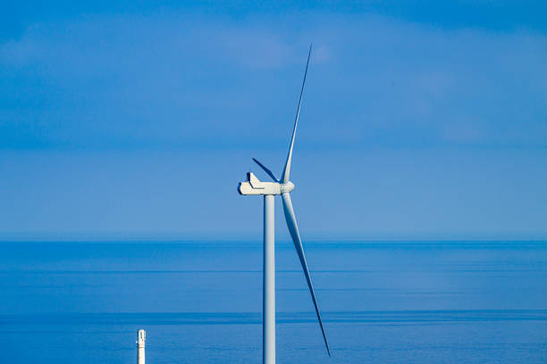 Wind power turbine in a hilly landscape.
