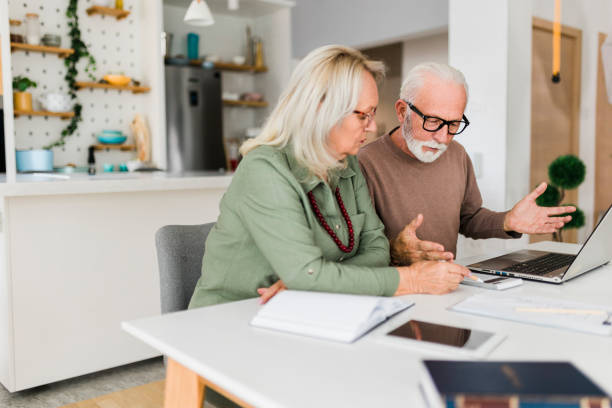 istock Senior couple using laptop while planning their home budget, 2177593727