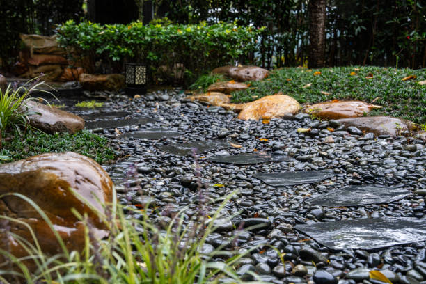 Decorative sprinkling of flowerbed paths with pebbles