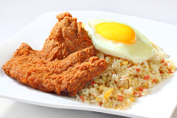delicious ham chicken, egg, fried rice in white plate on brown background premium western cafe halal food menu for restaurant