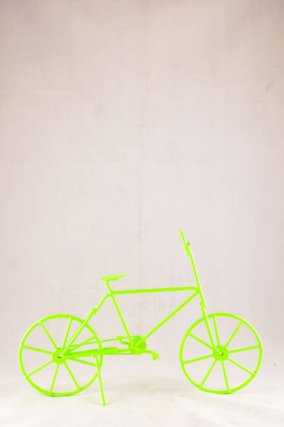 istock A green bicycle with a yellow frame is sitting on a white background 2177601935