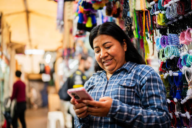Mature woman using mobile phone at store