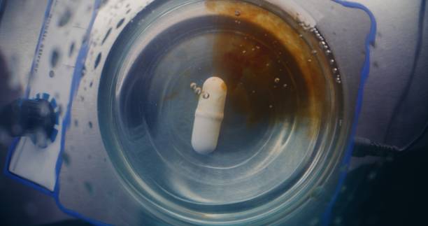 istock Chemist adds liquid in glass flask. Magnetic stirrer stirring fluid materials 2177606695